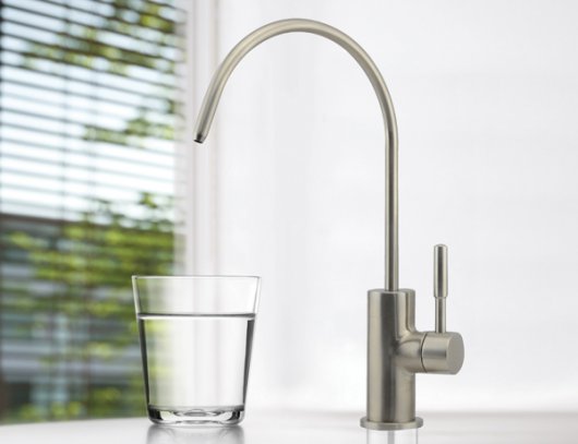 a faucet pouring water into a glass