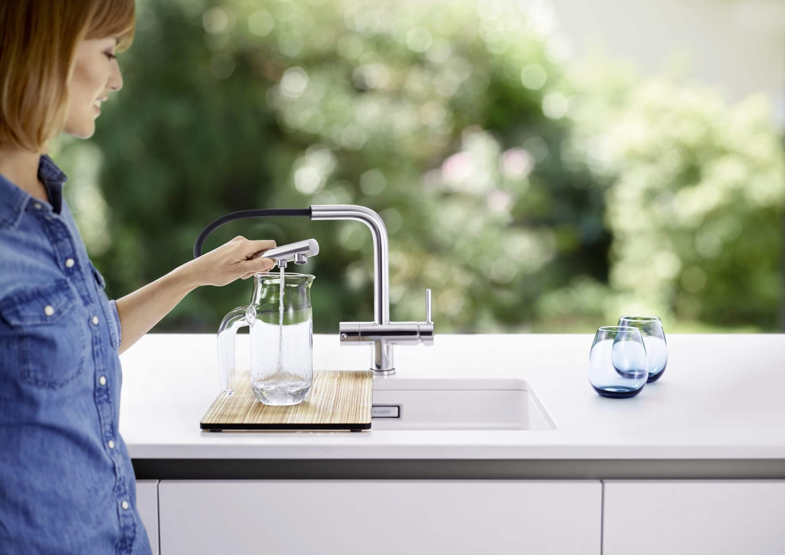 a person pouring a liquid into a glass